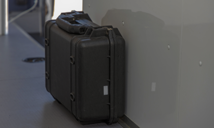 Black, upright hardcase on the floor of a cargo van